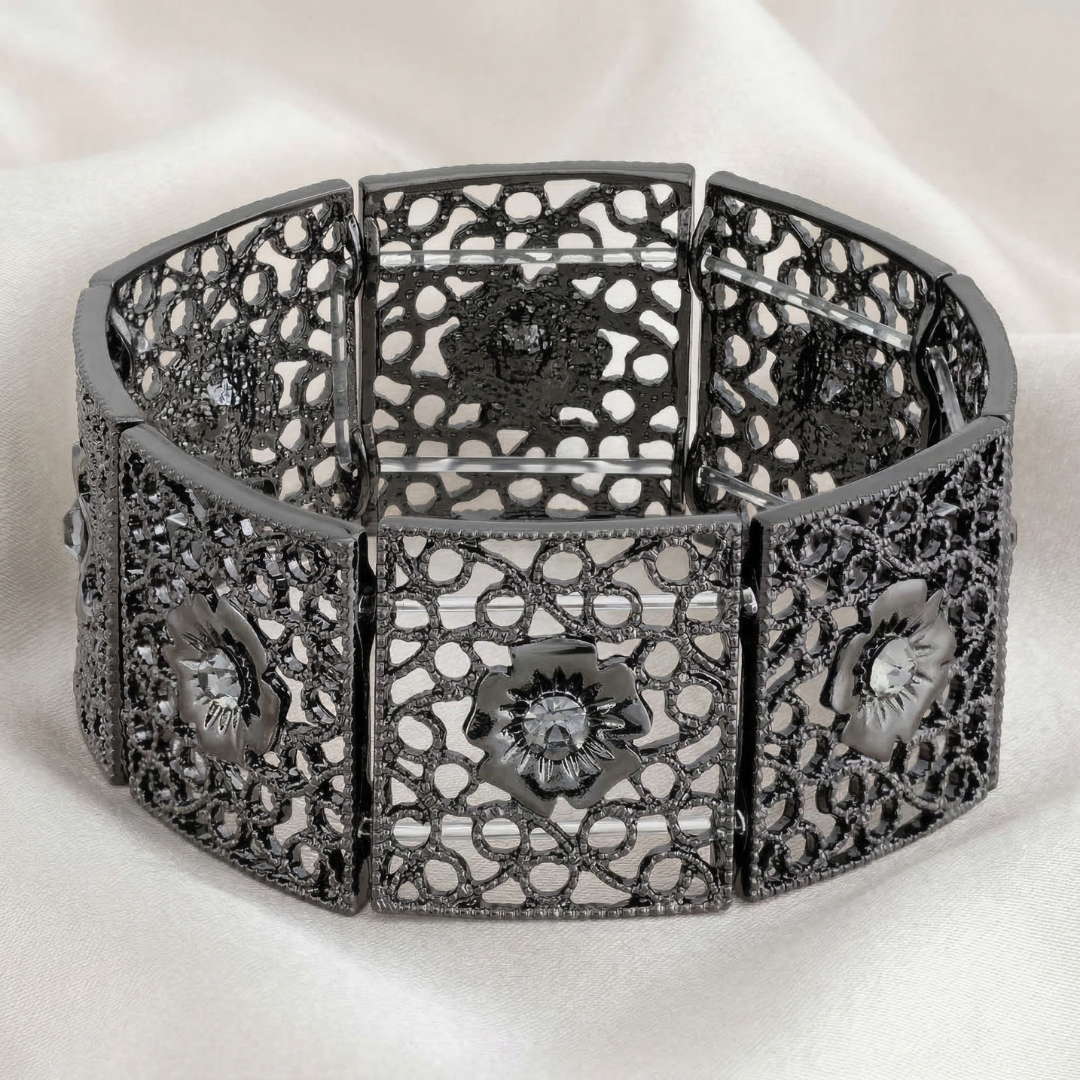 Decorative black metal stretch bracelet with floral designs on a white background