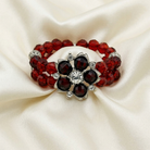 Bracelet with red and black beaded crystals on a beige fabric background