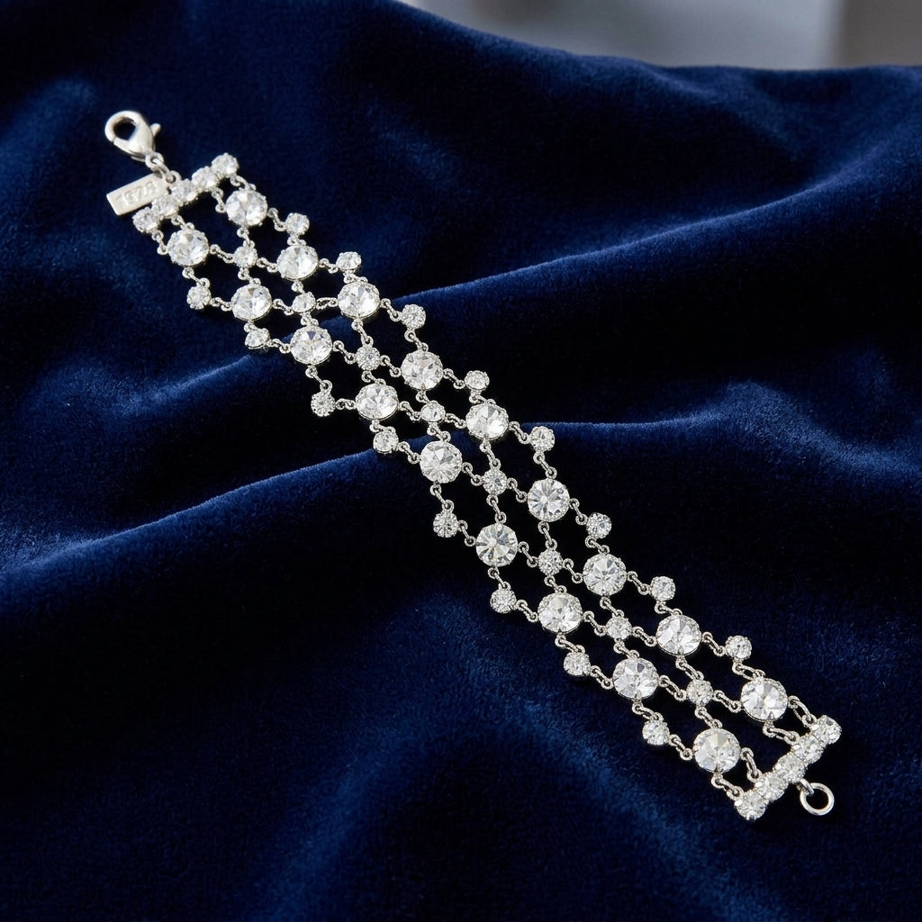 Silver bracelet with clear Austrian crystals on a dark blue fabric background