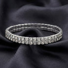 Silver bracelet with clear crystals on a dark fabric background