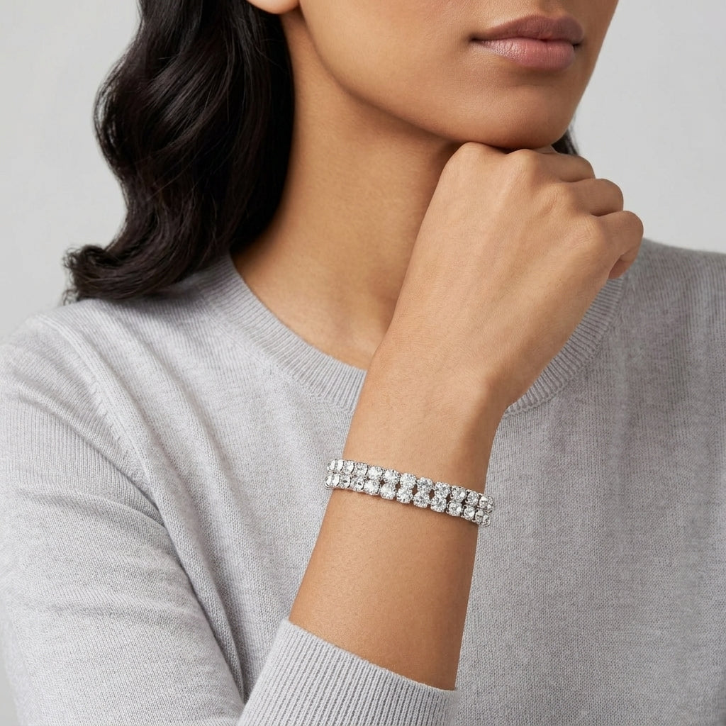 Woman wearing a silver bracelet on a neutral background