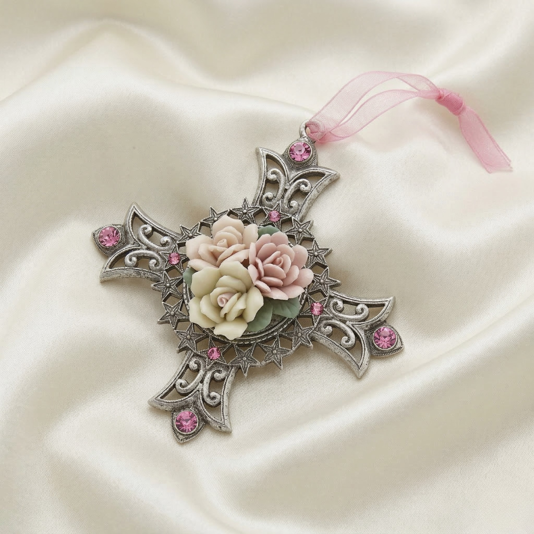 Decorative cross ornament with genuine porcelain rose and pink crystals with pink ribbons on a satin background