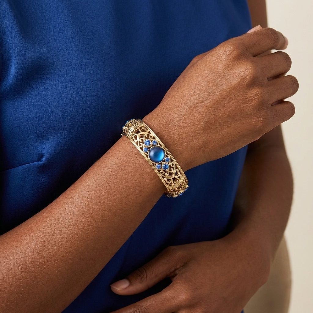 Gold Tone Blue Genuine Mother Of Pearl Crystal Accent Stretch Bracelet on a person wearing a blue dress.
