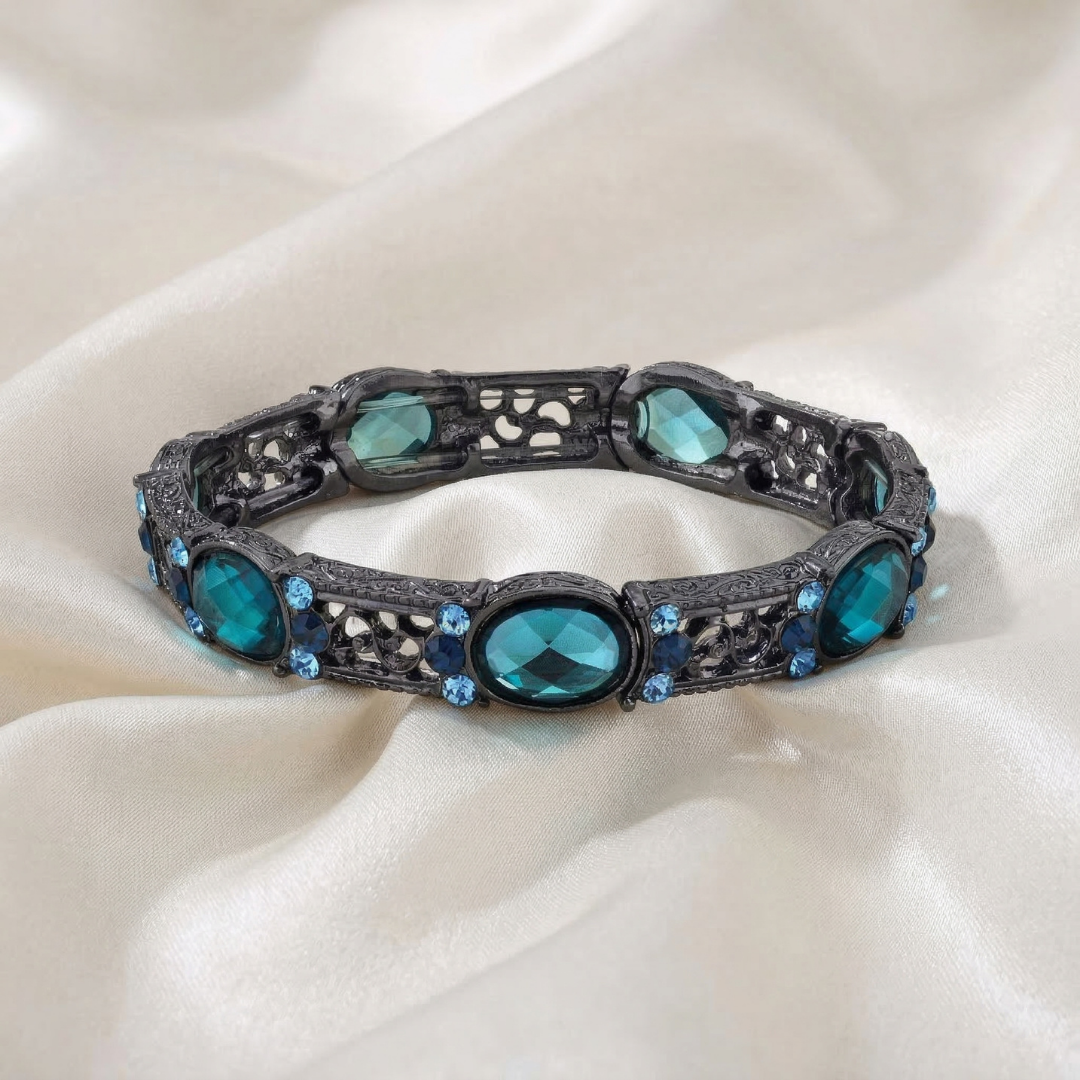Decorative bracelet with blue crystals on a white fabric background