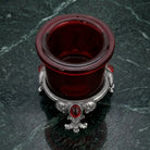 Pewter Votive Oval Red Stone Glass Candle Holder on a dark marble surface