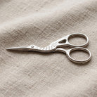 Embroidery Crane Bird Scissors on light colored linen