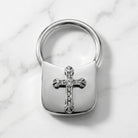 Silver tone Crystal Cross Key Chain on marble stone surface