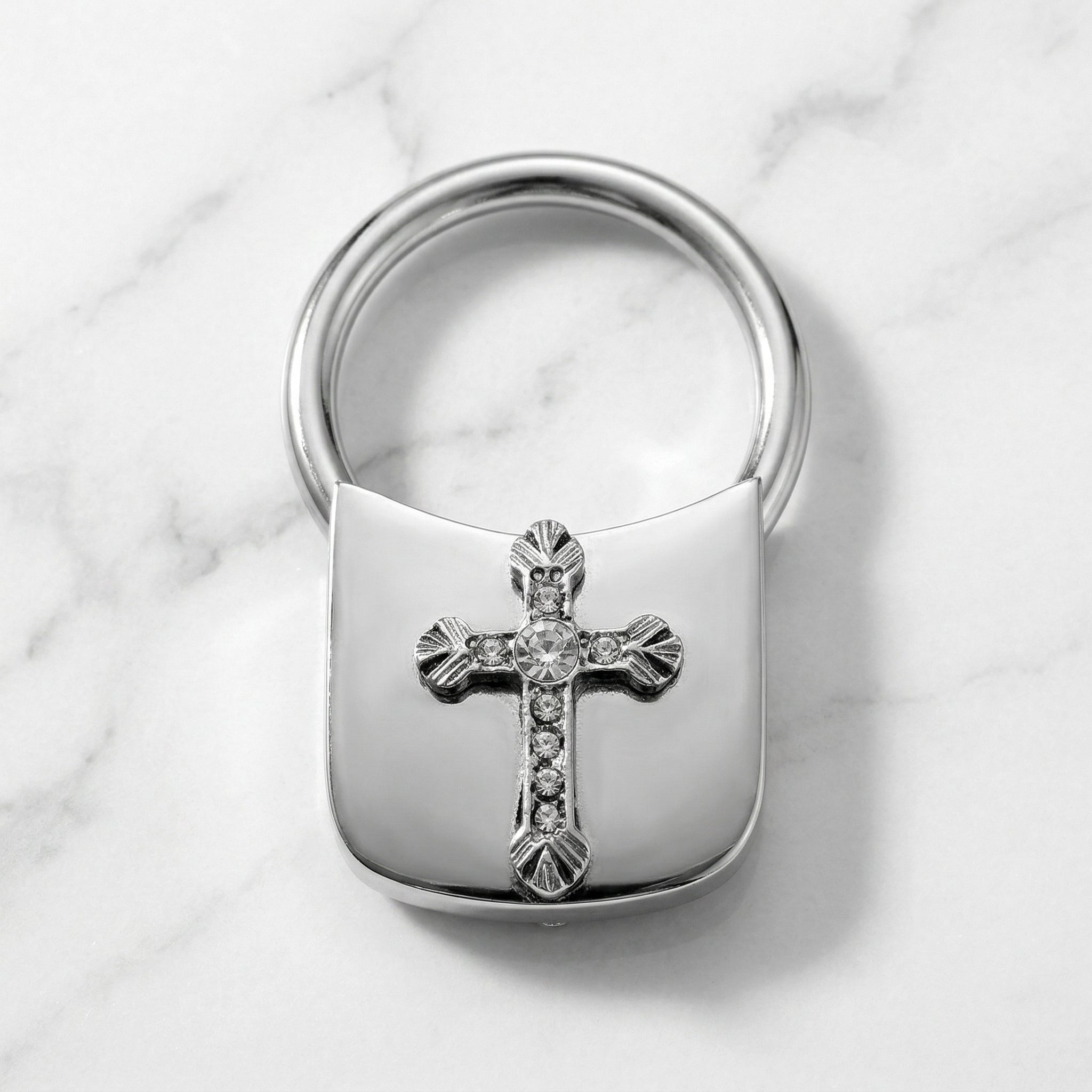 Silver tone Crystal Cross Key Chain on marble stone surface