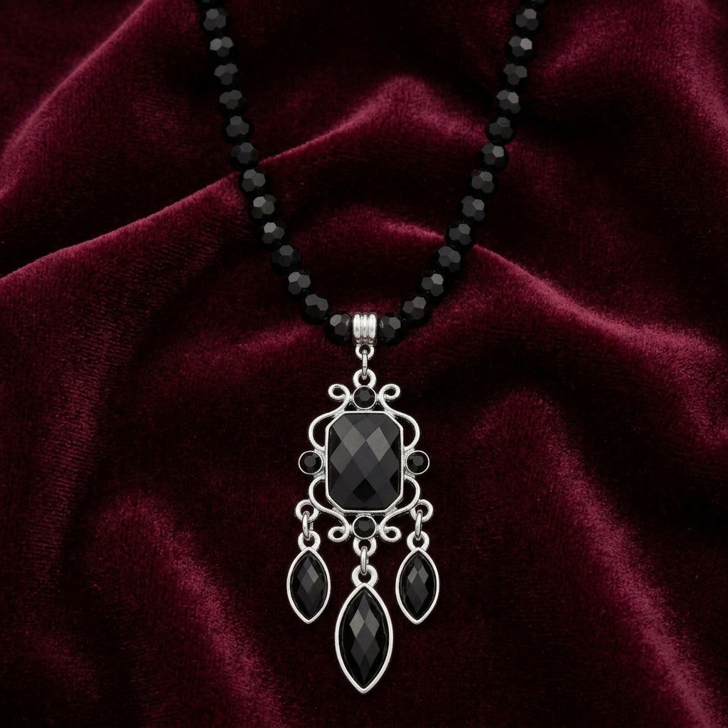 Triumphant Chandelier Black Strand Pendant Necklace on dark red velvet