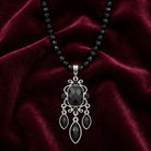 Triumphant Chandelier Black Strand Pendant Necklace on dark red velvet