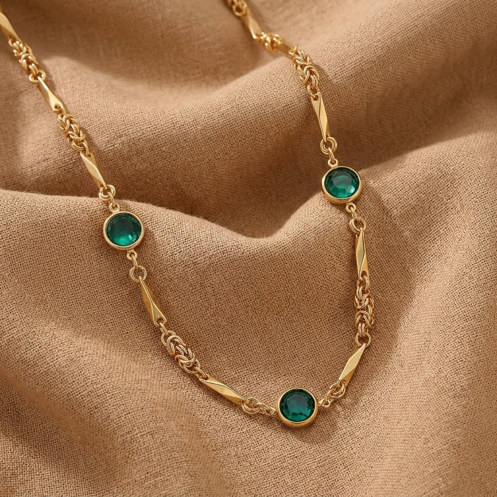 Gold tone Green Austrian Channel Crystal Fancy Necklace on a beige fabric background