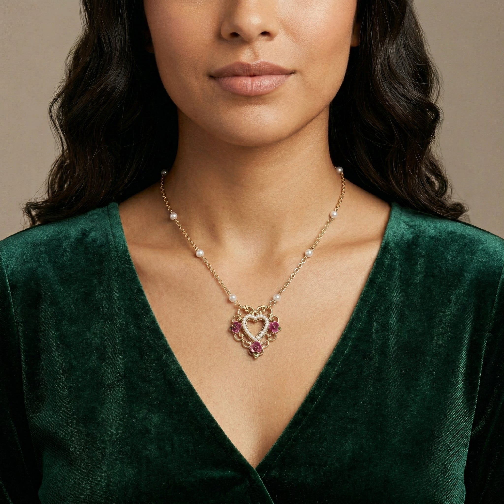 Woman wearing a green velvet top with a Pink Enamel Flower Faux Pearl Rimed Open Heart Pendant Necklace