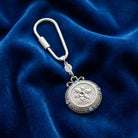 March Crystal Flower of The Month Carabiner Key Chain resting on a blue fabric background