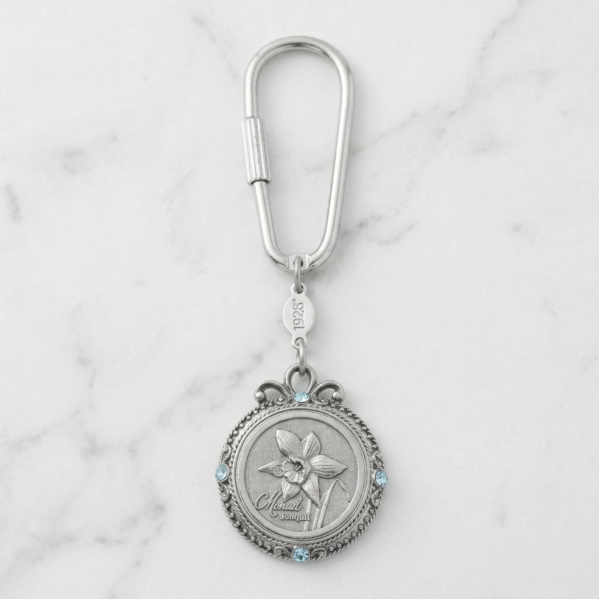 March Crystal Flower of The Month Carabiner Key Chain resting on marble surface