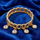 Gold tone Round Multi Crystal Link Stretch Bracelet on a blue velvet background