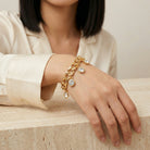 Person wearing a gold tone Round Multi Crystal Link Stretch Bracelet 
