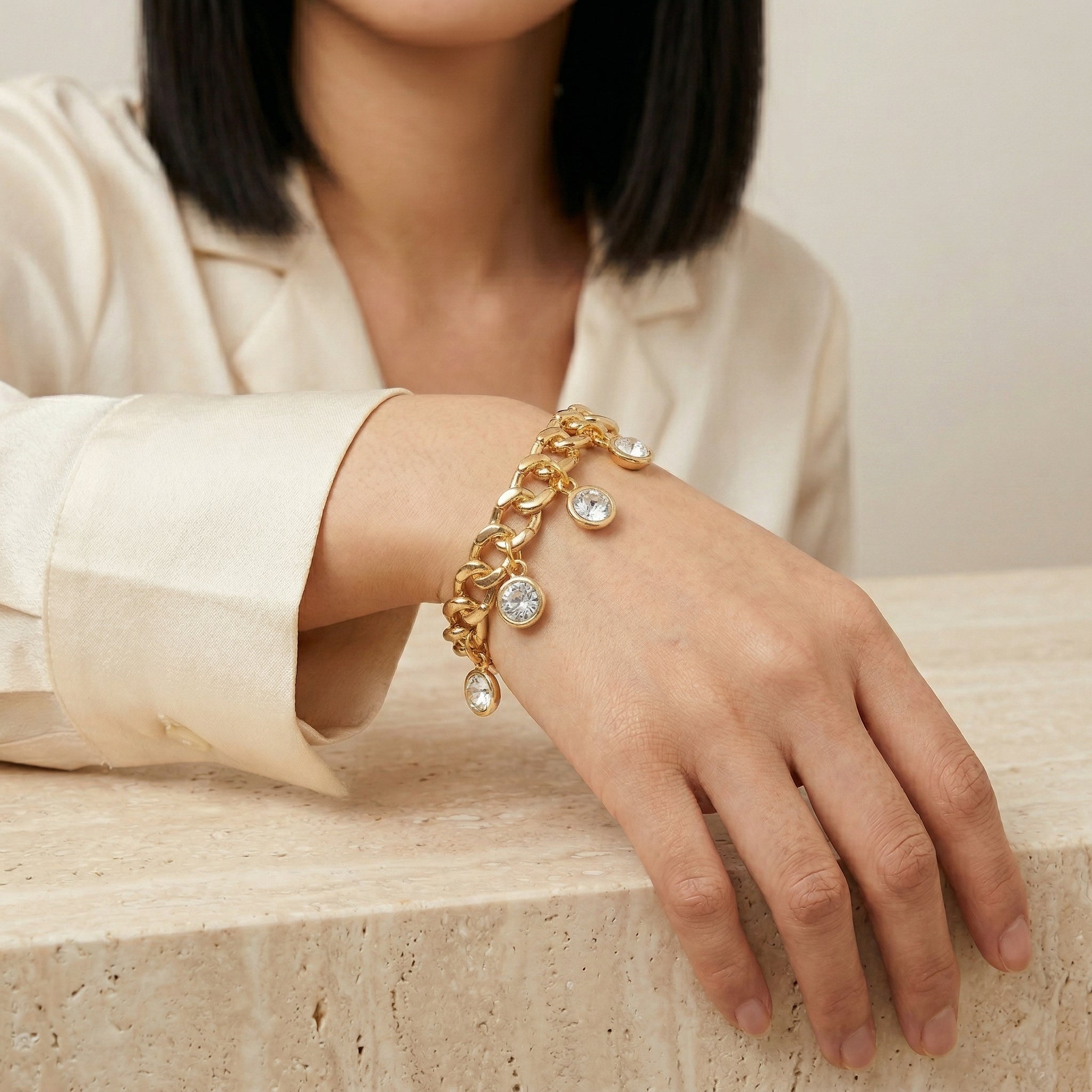 Person wearing a gold tone Round Multi Crystal Link Stretch Bracelet 