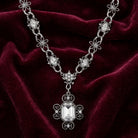 Elegant silver necklace with a large octagon clear crystal pendant on a burgundy velvet background