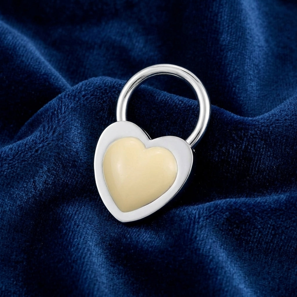 Silver tone Ivory Stone Heart Key Ring on a blue fabric background