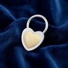 Silver tone Ivory Stone Heart Key Ring on a blue fabric background