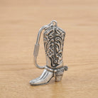 Pewter Cowboy Boot Carabiner Key Chain on a wooden surface