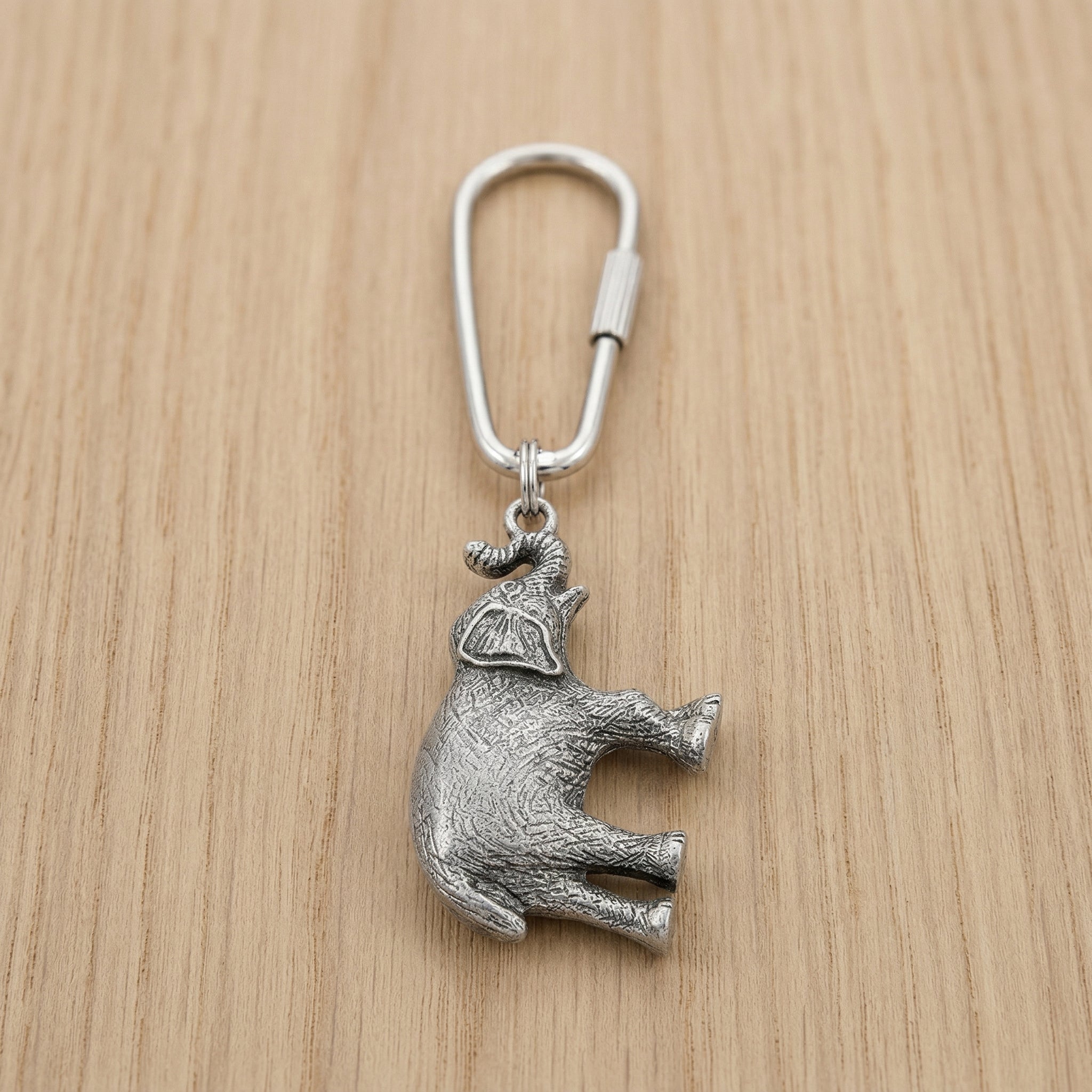 Pewter Elephant Key Ring on a wooden surface
