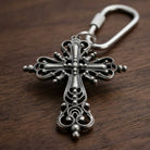 Classical silver tone Cross Carabiner Key Chain on a wooden surface