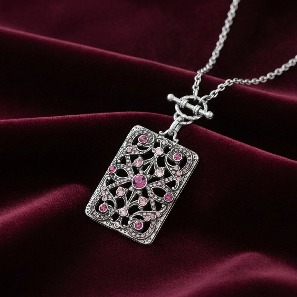 Silver tone Purple Amethyst Crystal Filigree Mirror Pendant Necklace on a maroon fabric background