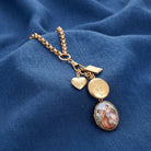 Gold tone Victorian Art Locket Plus Book & Heart Lockets Necklace on blue linen