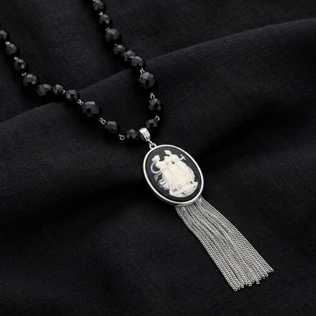 Grecian Women & Water Pitcher Cameo Pendant Tassel Necklace on a dark fabric background