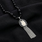Grecian Women & Water Pitcher Cameo Pendant Tassel Necklace on a dark fabric background