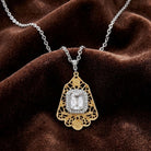 Gold and silver crystal pendant necklace on a brown velvet background