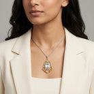 Woman wearing a gold and silver tone Ornate Filigree Statement Crystal Pendant Necklace 