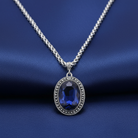 Necklace with a blue gemstone pendant on a blue background