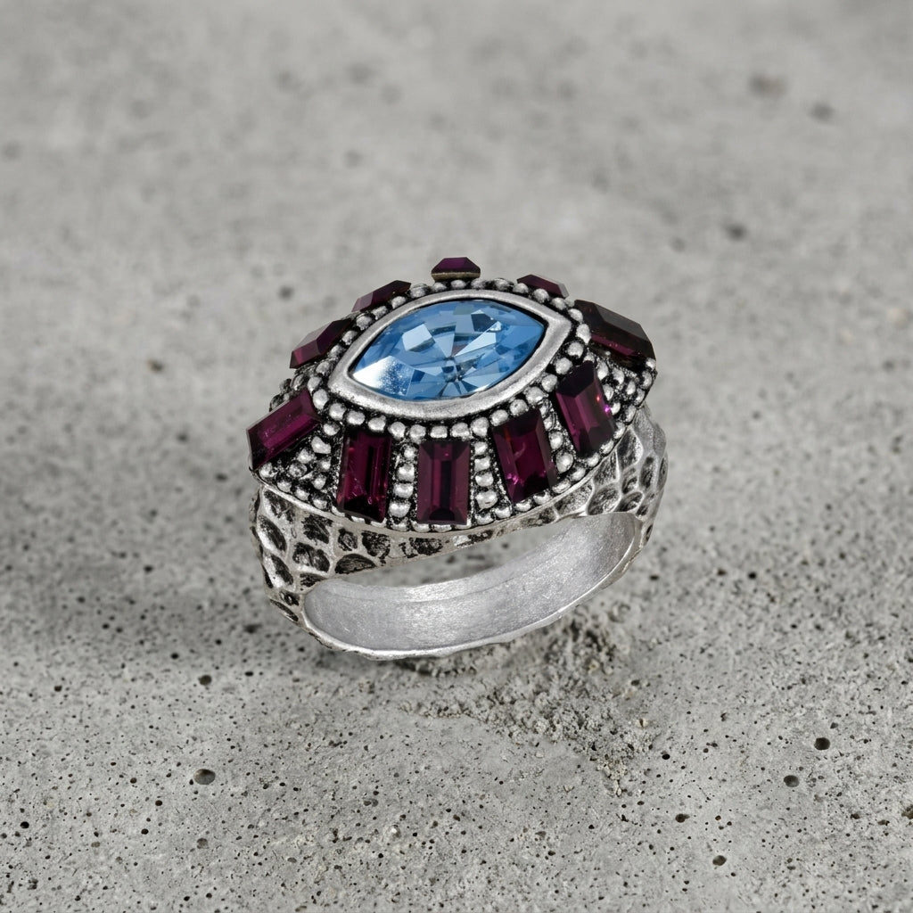 Honora Hammered Purple & Light Sapphire Crystal Ring  on a gray cement surface