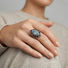 Hand wearing a decorative Honora Hammered Purple & Light Sapphire Crystal Ring