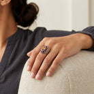 Close-up of a hand wearing a decorative Honora Hammered Siam Red & Topaz Crystal Ring