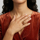 Woman wearing a red velvet top with a Sunburst Oval Smoke Topaz Glass Stone Crystal Ring