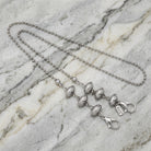 Stainless Steel Football Face Mask Chain on a marble surface