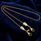 Gold Violin Pendant Mask Chain Holder on dark blue fabric