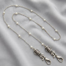 Silver tone Golf Club Set White Faux Pearl Face Mask Chain Holder on light colored fabric