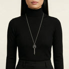 Person wearing a black turtleneck and a long Antiqued Heart Whistle Pendant Necklace