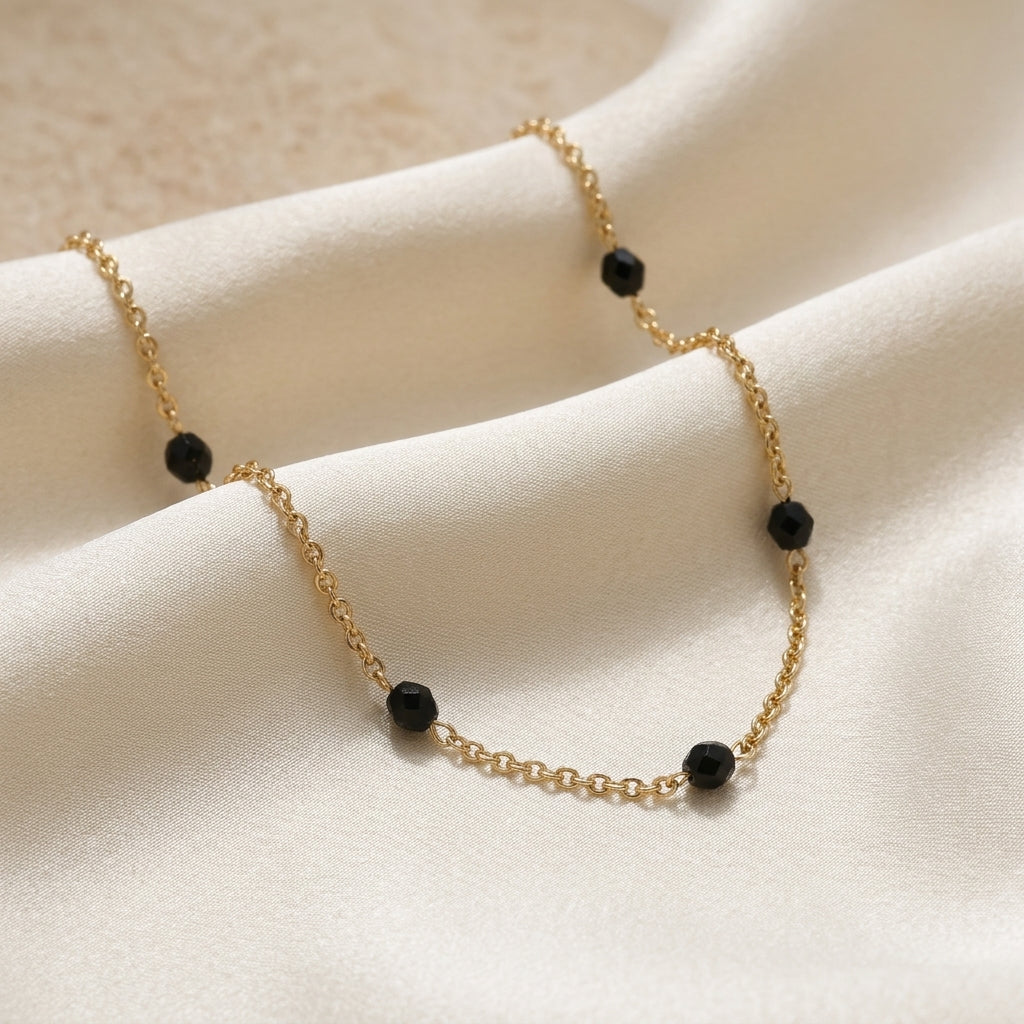 Minuit Black Glass Beaded Link Necklace on white fabric