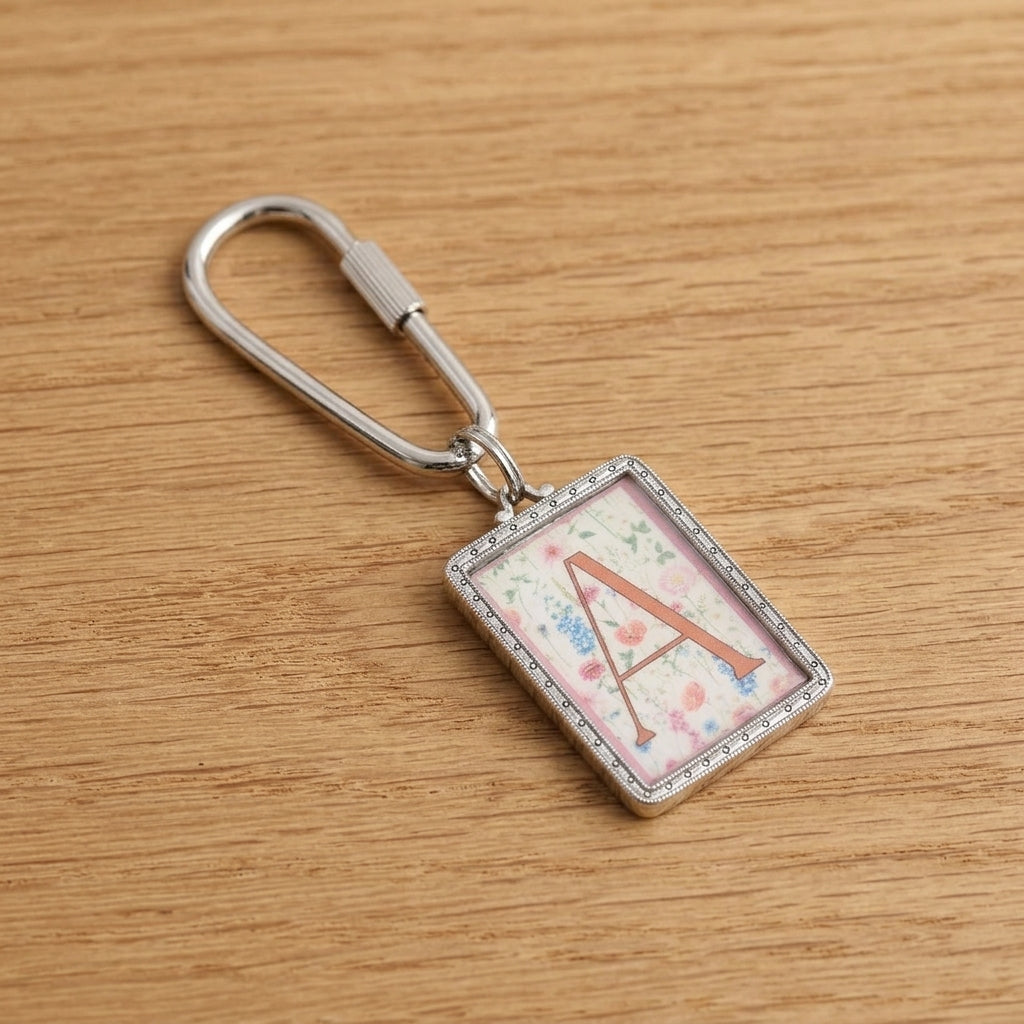 Pink Floral Motif "A" Initial Carabiner Key Chain on a wooden surface
