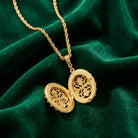 Gold necklace with a locket on a green velvet background