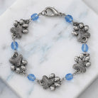 Paws & Light Sapphire Blue Glass Bead Bracelet on a marble surface