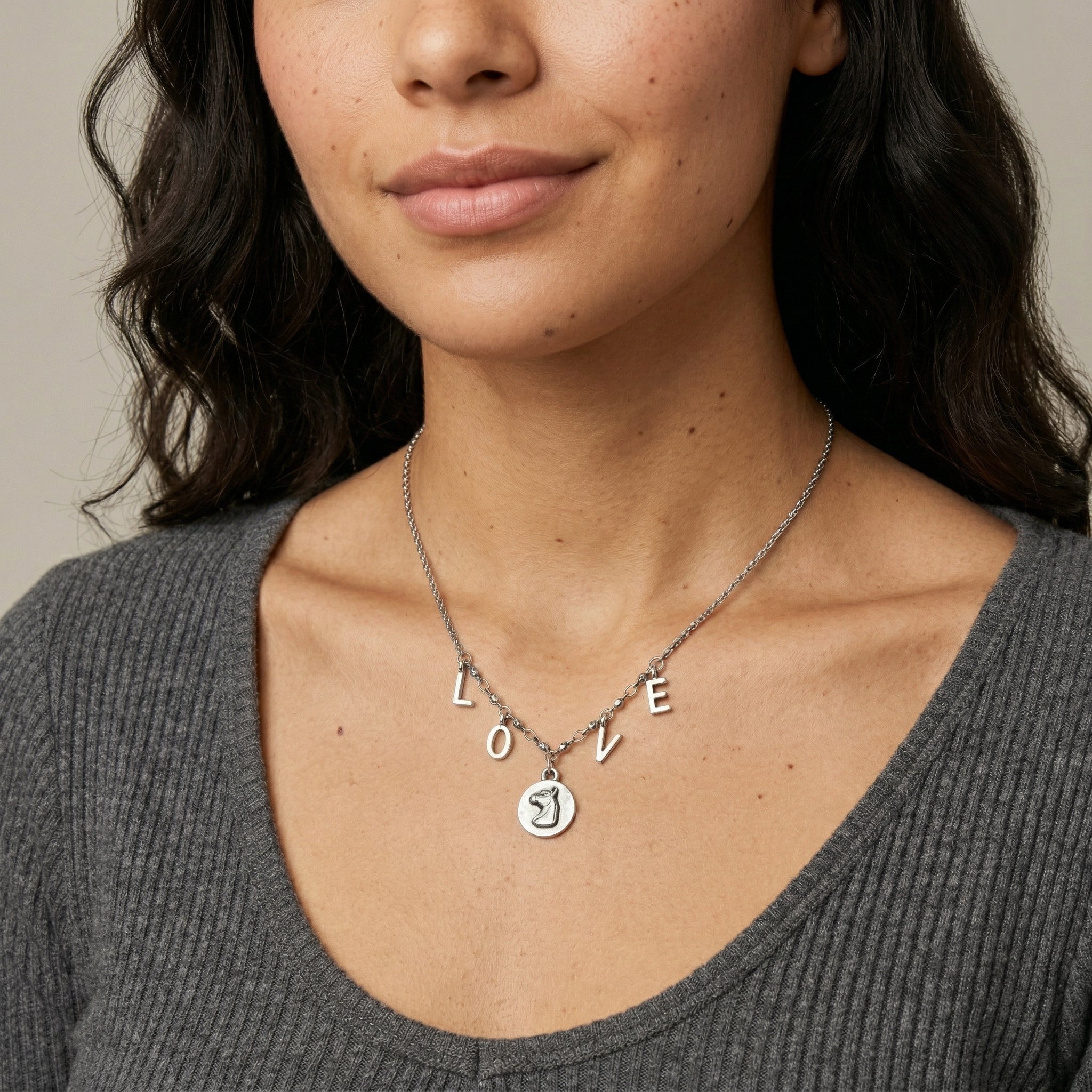 Woman wearing a Petite Horse Head Pendant LOVE Initials Necklace