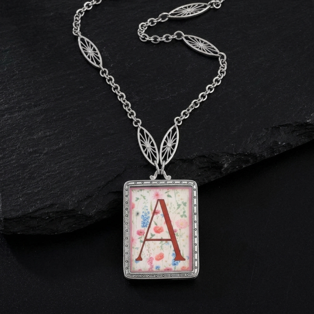 Necklace with a pendant featuring the letter 'A' on a dark stone background