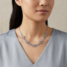Light Blue Sapphire Bead Pewter Paw Necklace worn by a person against a neutral background