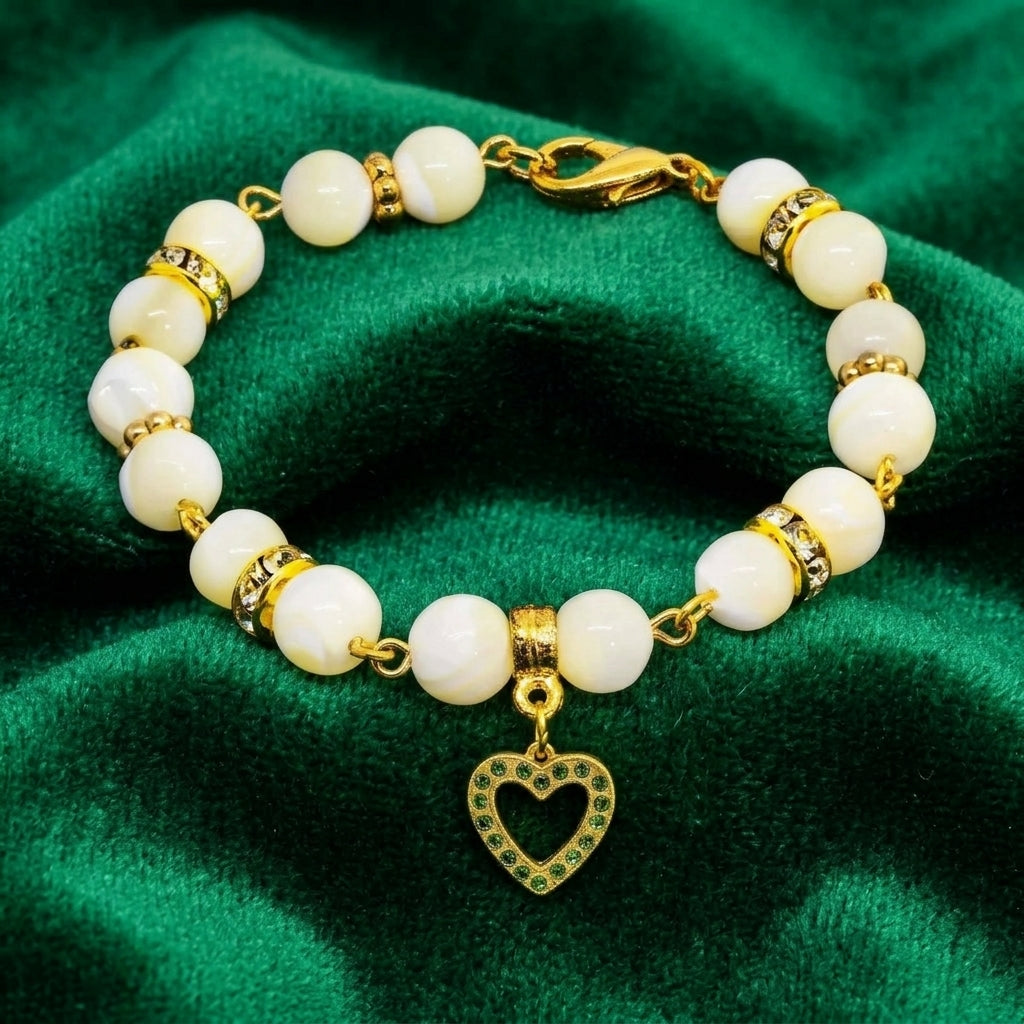 Mother of Pearl Crystal Birthstone Heart Charm Bracelet on green fabric